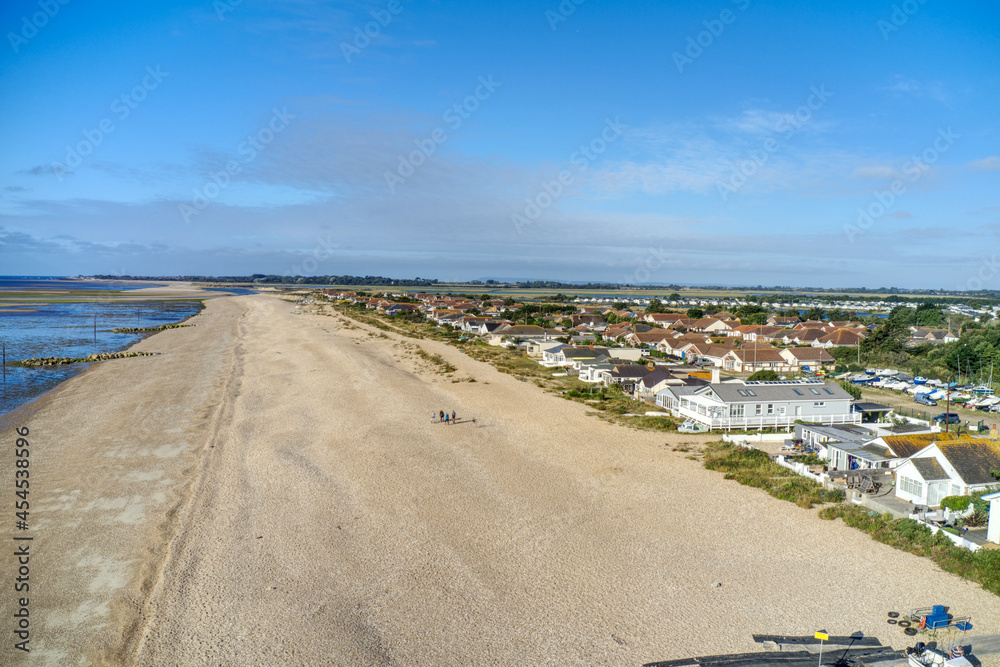Aerial view along Pagham beach in West Sussex, with the Pagham Harbour entrance and nature reserve in view.
