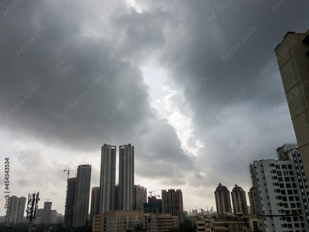 Dramatic monsoon clouds above a skyline of high rise apartment buildings in Kandivali in suburban Mumbai.