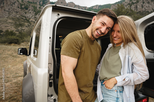 Young happy couple on a road trip sitting in car trunk © fotofabrika