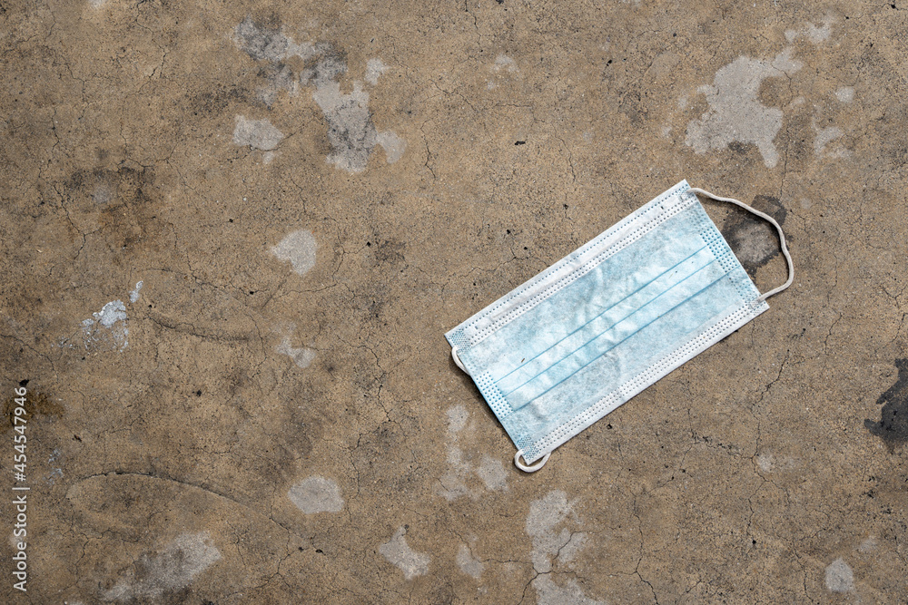 Toxic waste from masks used to protect against coronavirus is dumped on the cement floor, polluting the environment. Toxic waste from masks used to protect against coronavirus is dumped on the cement floor, polluting the environment.