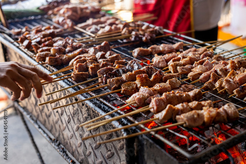 Grilled pork milk with wood stick, street food in Laos