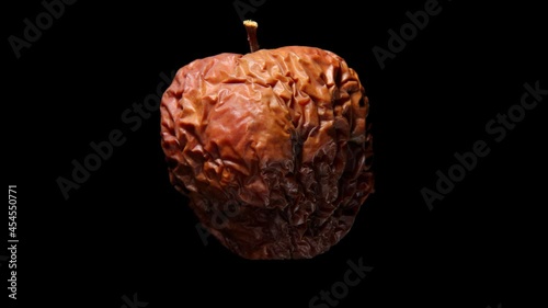Fresh ripe green apple quickly wither to ugly brown shriveled lump. Time lapse shot, fruit isolated on black. Aging as natural process concept. Light skin change color first, then shape changed photo