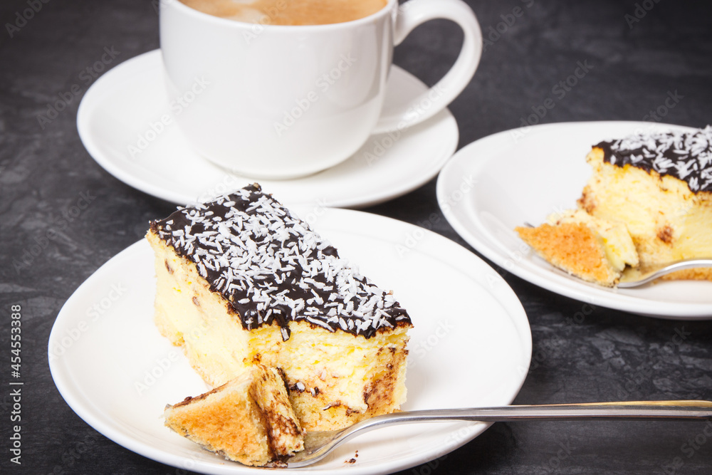 Fresh baked cheesecake and cup of coffee with milk. Delicious dessert Fresh baked cheesecake and cup of coffee with milk. Delicious dessert