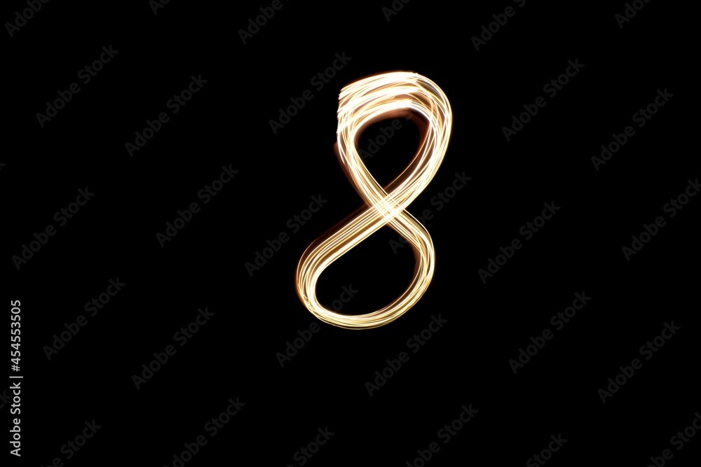 Light painting number 8. Number eight drawn with gold lights. Light painting number 8. Number eight drawn with gold lights.