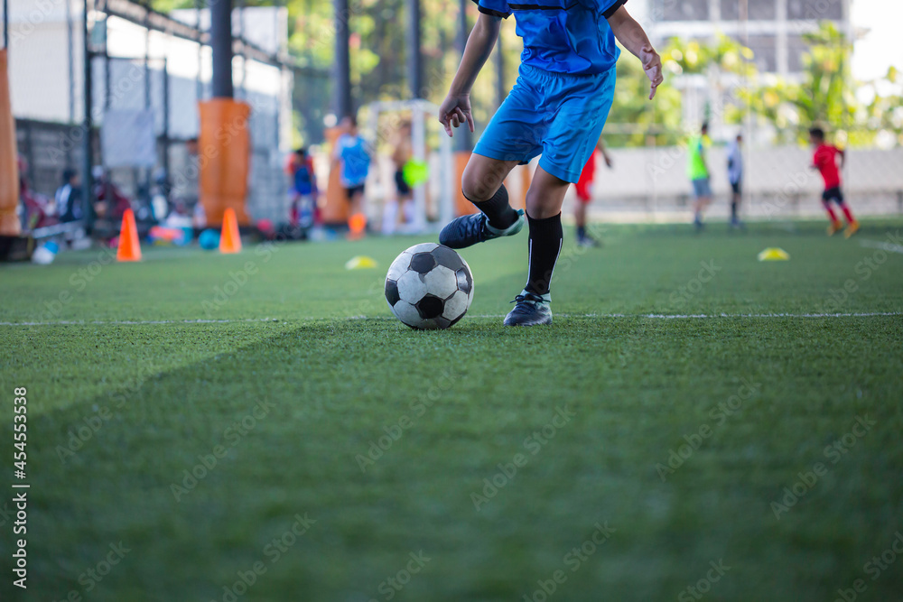 Obraz premium Children playing control soccer ball tactics on grass field with for training
