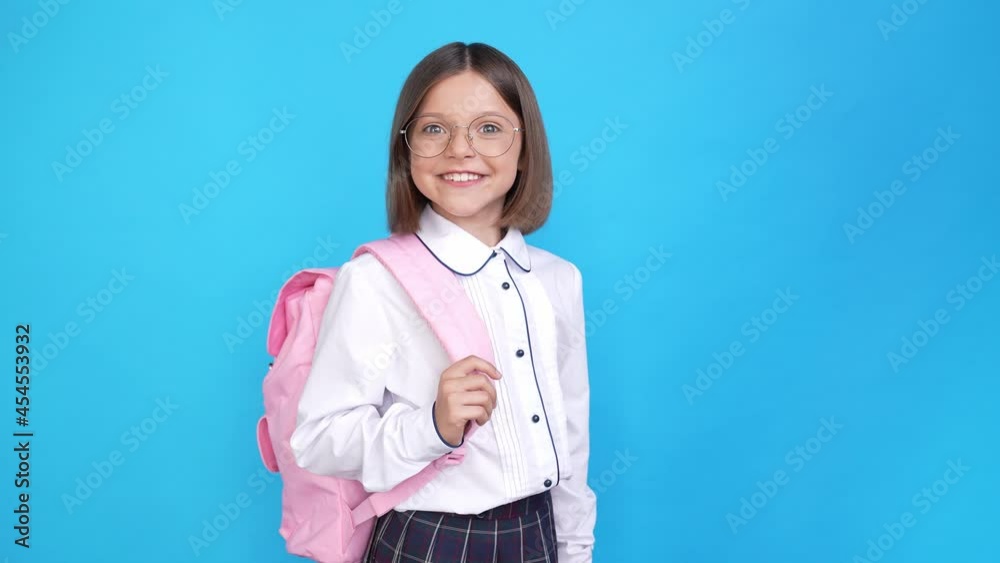 Cheerful positive reliable little lady hold backpack raise thumb up Cheerful positive reliable little lady hold backpack raise thumb up