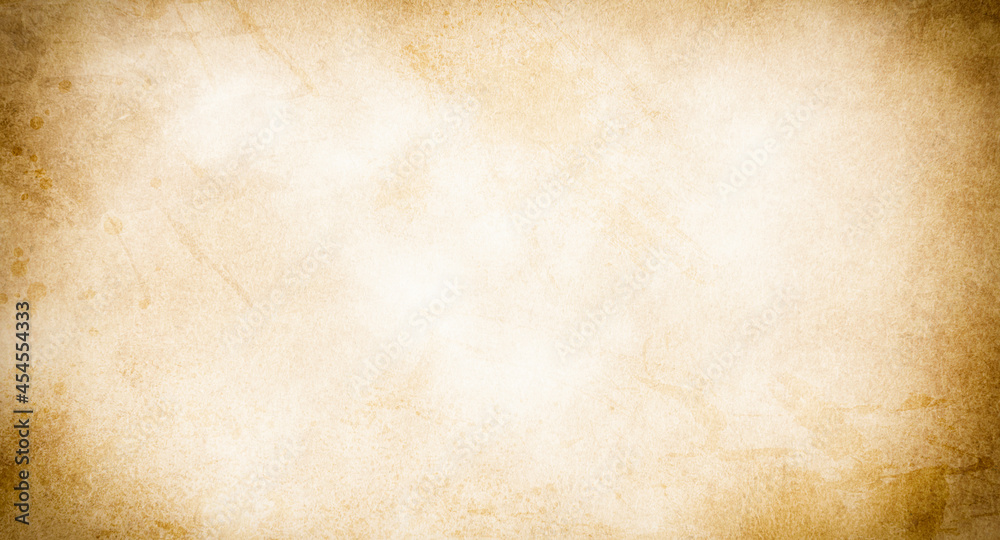 Obraz premium An old stained blank sheet of beige paper with a vignette