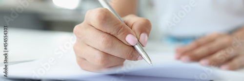 Woman hand makes entries in diary closeup