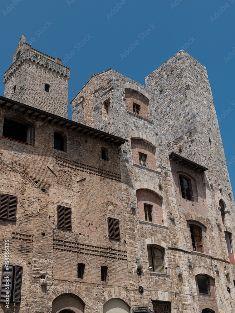 The historic center of San Gimignano, a typical medieval village in Tuscany. Narrow streets, numerous stone towers characterize the urban landscape