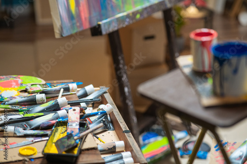 Drawer,cabinet of the artist, painter with scattered, disordered paints in a tube, paint brushes, paints artistic mess in the paint store, in the studio.
