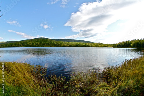 Beautiful clear lake in a forest landscape with blue sky in Khakassia