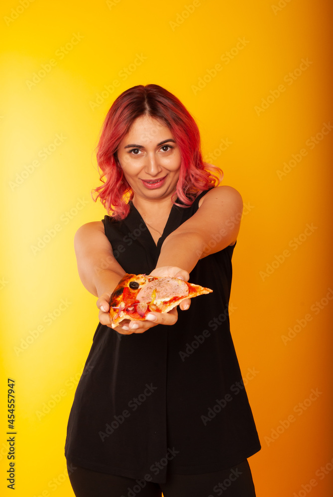 a girl holds out a fast food pizza in her hands to the camera holding directly into the frame