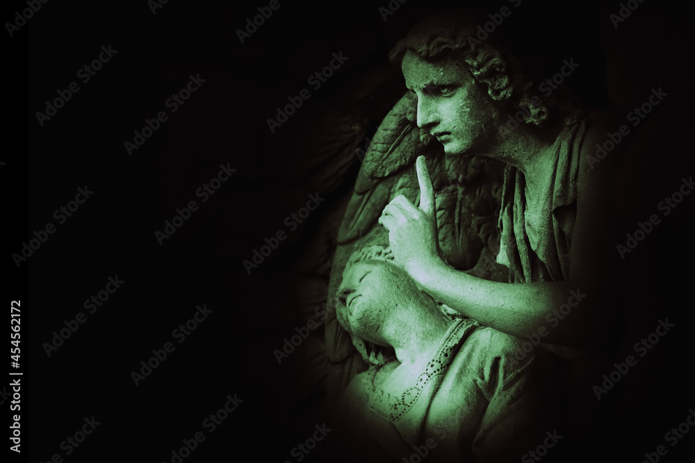 Dramatic image of sad angel with dead person. Fragment of an ancient statue. Death and pain concept. Copy space. Dramatic image of sad angel with dead person. Fragment of an ancient statue. Death and pain concept. Copy space.