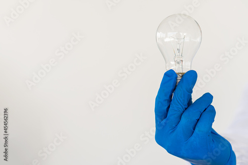 a light bulb in a doctor's hand on a white background