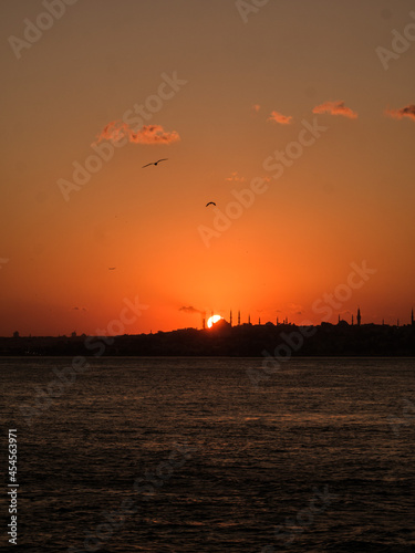 View from the sea druing sunset over the mosque