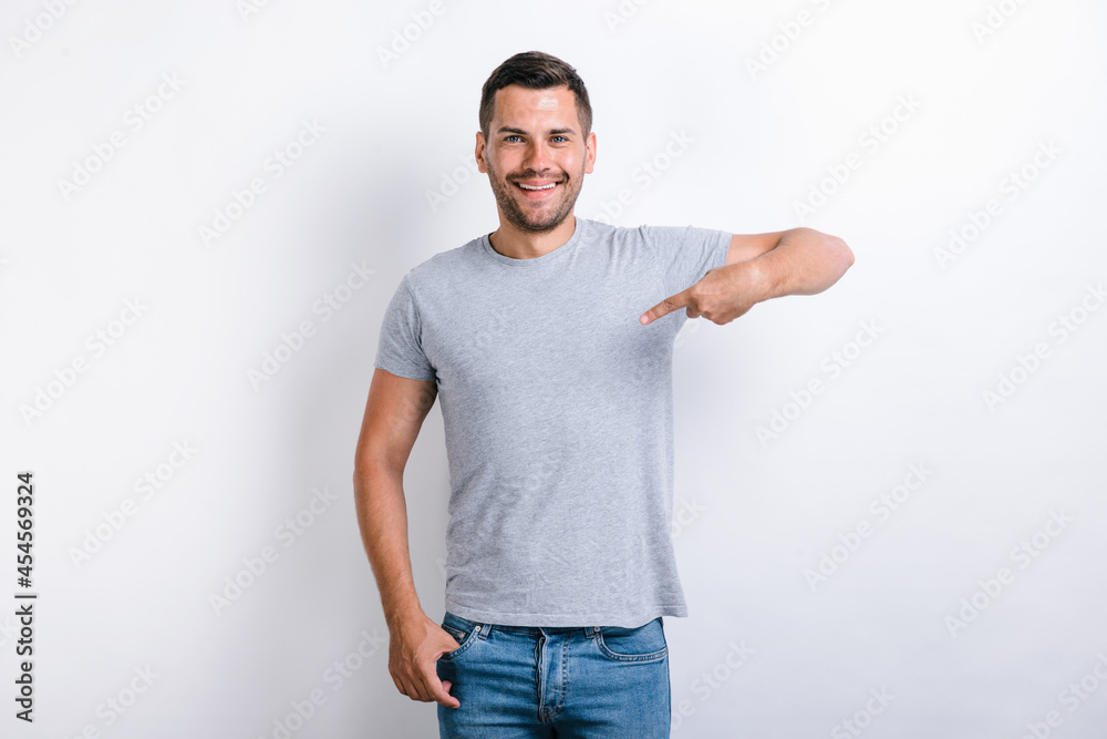 It's me! Ambitious young man with toothy smile on face pointing with finger on himself, confident teenager. Indoor studio shot isolated on white background It's me! Ambitious young man with toothy smile on face pointing with finger on himself, confident teenager. Indoor studio shot isolated on white background