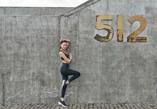 Beautiful fitness woman in black sport suit 