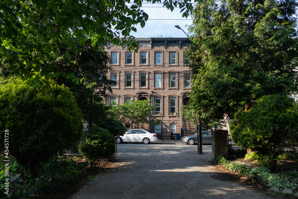 Walkway at Van Vorst Park with a Row of Old Brownstone Homes in Jersey City New Jersey