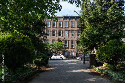 Walkway at Van Vorst Park with a Row of Old Brownstone Homes in Jersey City New Jersey © James