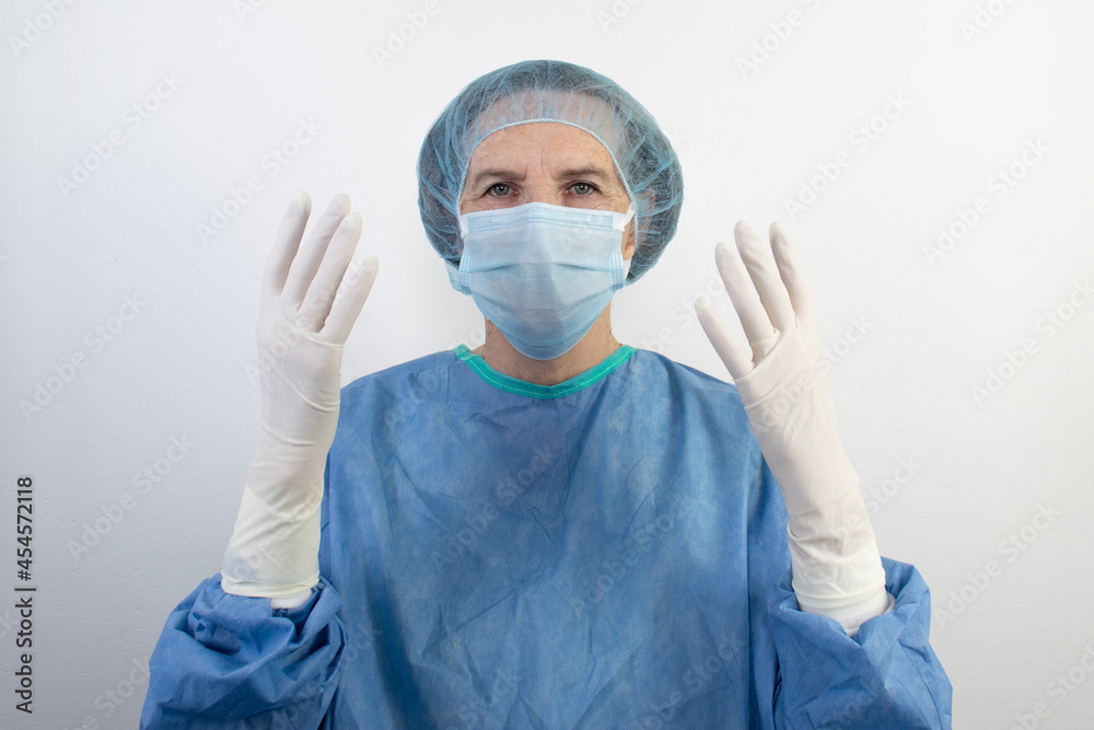 old senior female woman surgeon uniform doctor medical gloves surgical hair net