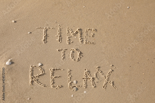 Phrase Time to Relax written on sand at beach, top view © New Africa