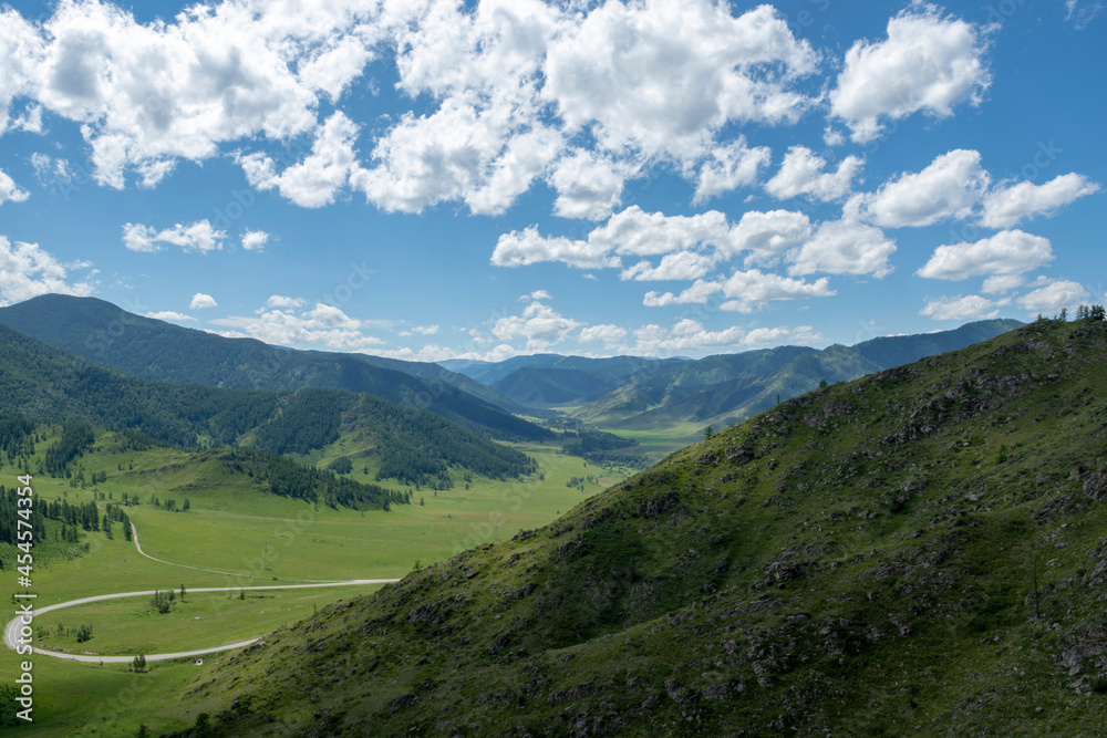 winding highway climbing a mountain pass on a summer day