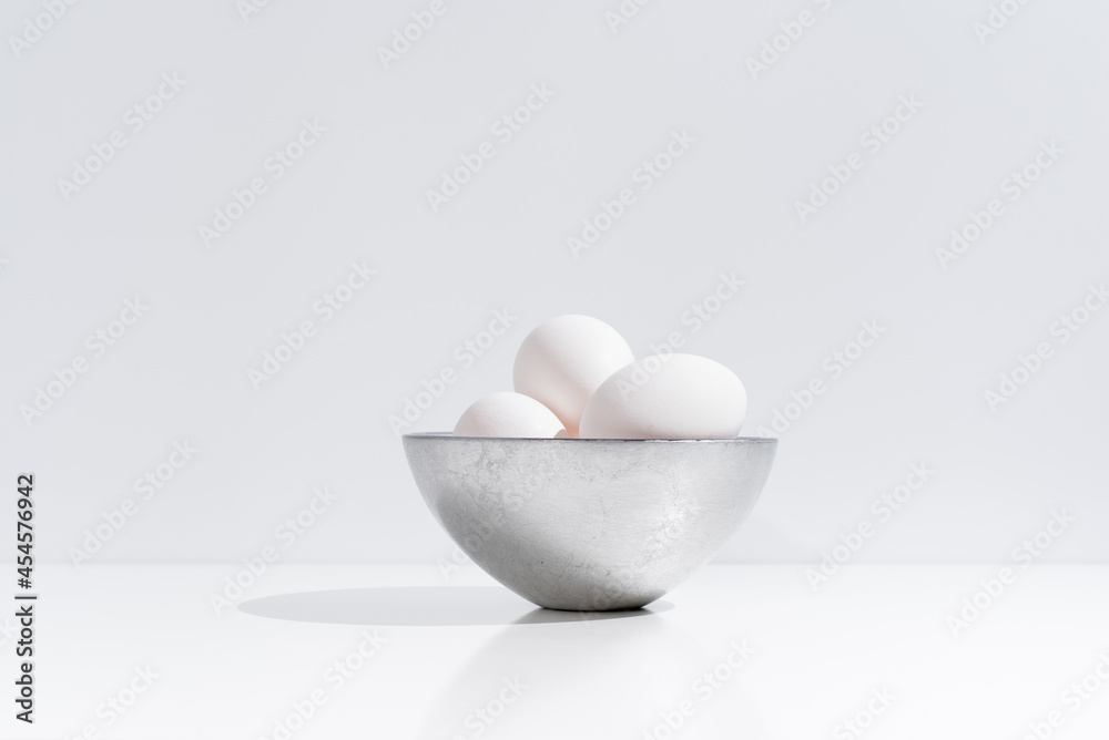 White chicken eggs in bowl on table White chicken eggs in bowl on table