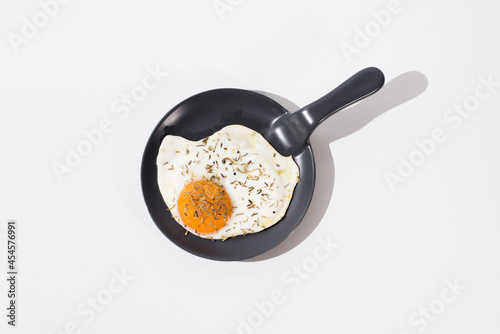 Tasty fried egg on skillet in white table photo