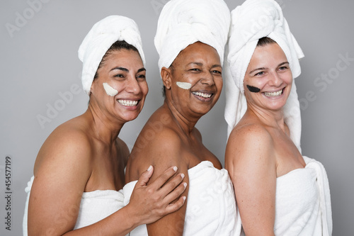 Multiracial mature women doing beauty treatment skin care together
