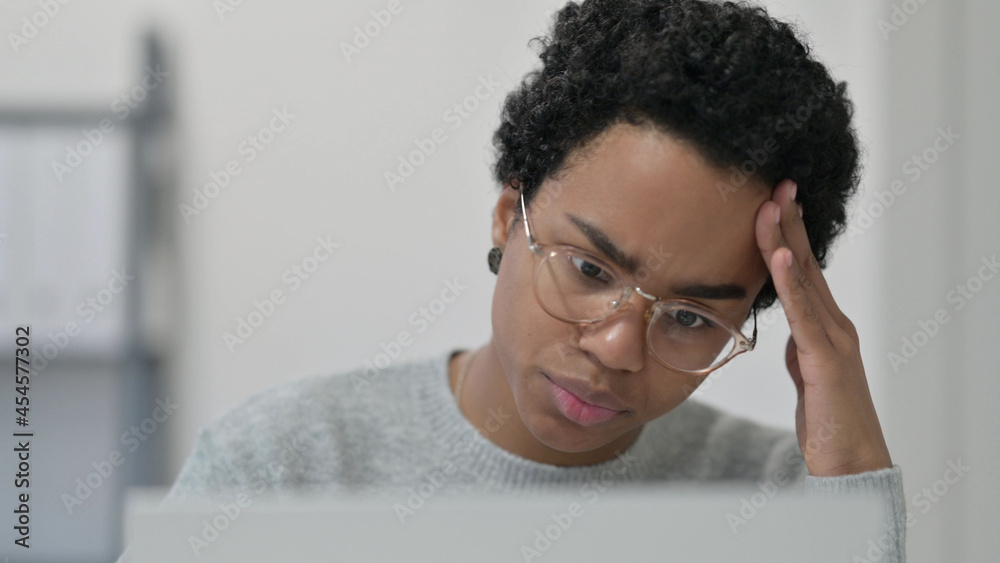 Close up of African Woman Thinking while using Laptop Close up of African Woman Thinking while using Laptop
