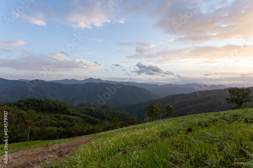 agricultural landscape of hill tribes green grass evening sky On top of a hill in Chiang Mai, Thailand. Background image. There is space for the text above.