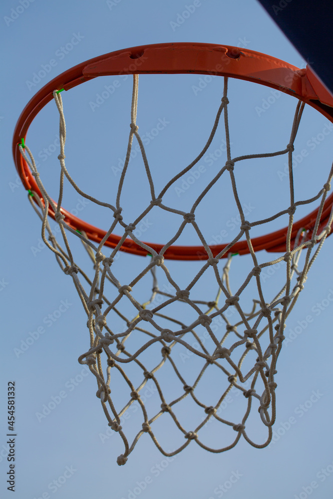 Red basketball ring with net on a background of blue sky. Sport concept Red basketball ring with net on a background of blue sky. Sport concept