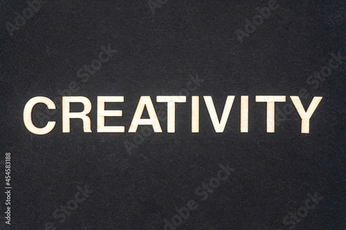 CREATIVITY word written on dark paper background. CREATIVITY text for your concepts