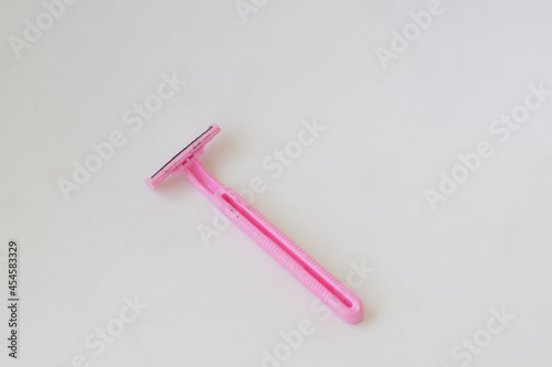 used pink beard razor on white isolated background