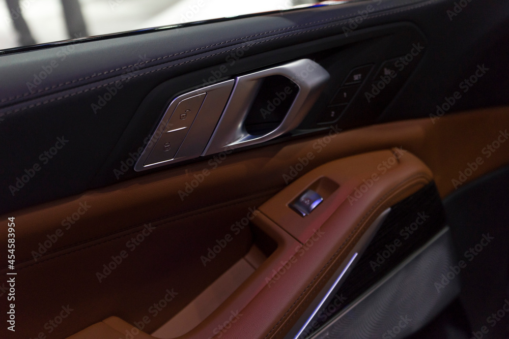 Close up of interior door handle of a modern premium car.