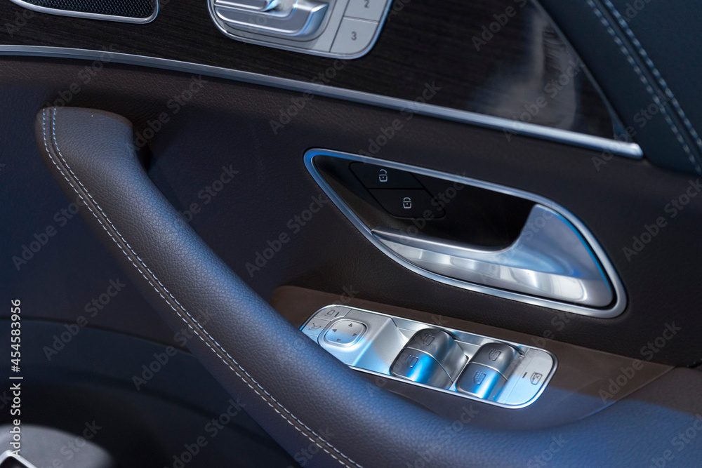 Close up of interior door handle of a modern premium car.