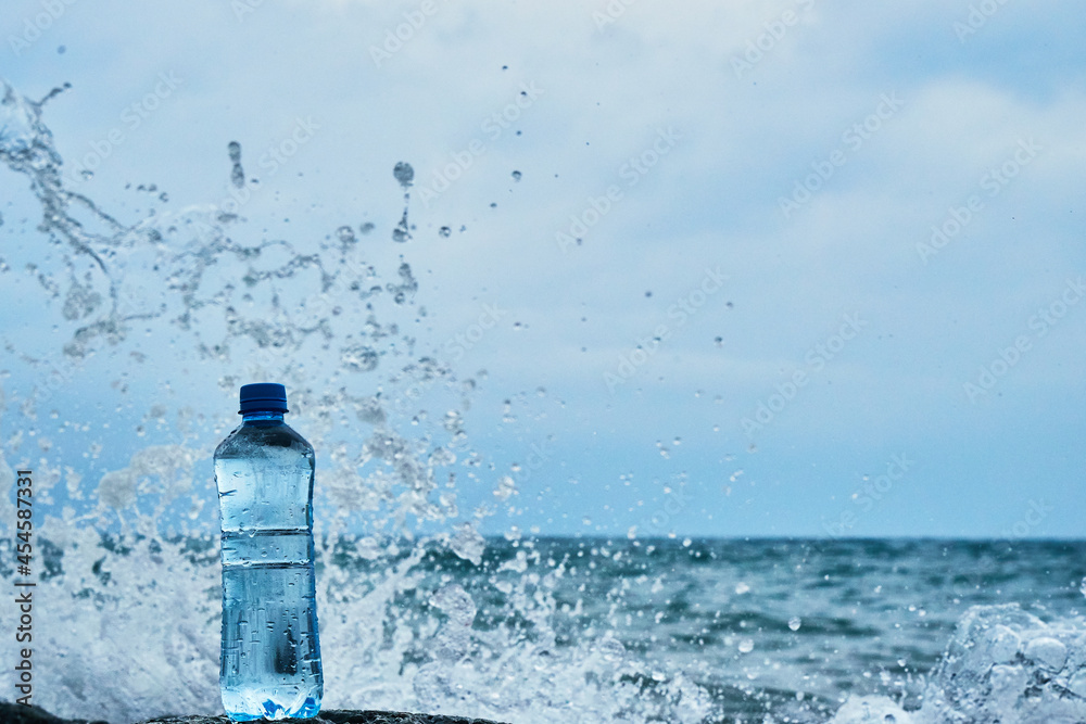 Plastic bottle. Coast of the sea. Waves hit the stones. Plastic bottle. Coast of the sea. Waves hit the stones.