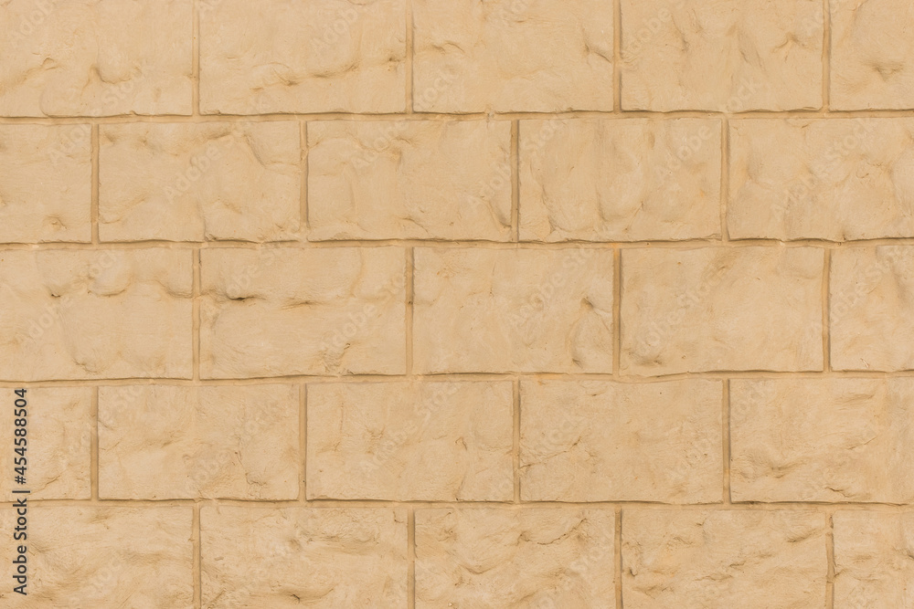 Fototapeta premium Sand color brick blocks clay masonry wall texture background