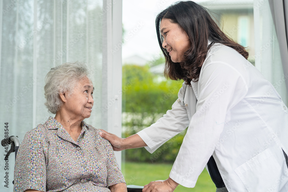 Doctor help and care Asian senior or elderly old lady woman patient sitting on wheelchair at nursing hospital ward, healthy strong medical concept Doctor help and care Asian senior or elderly old lady woman patient sitting on wheelchair at nursing hospital ward, healthy strong medical concept