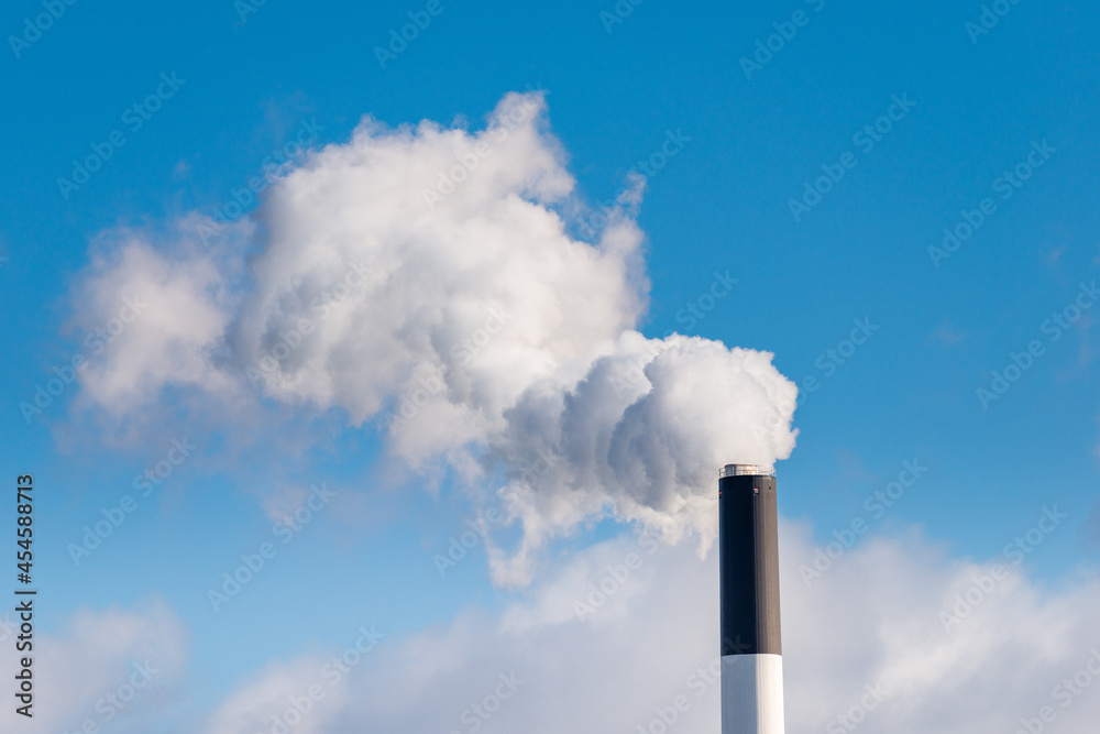 Chimney from power plant in Copenhagen, Denmark that produces electricity from Coal and Biomass. Chimney from power plant in Copenhagen, Denmark that produces electricity from Coal and Biomass.