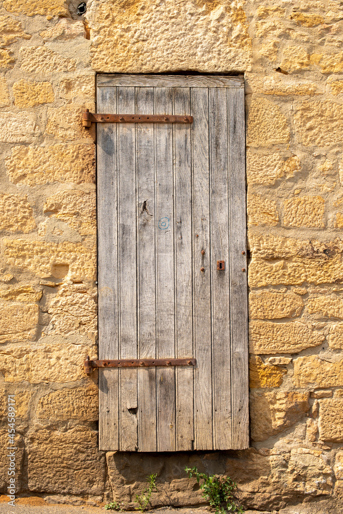 Old wooden door in Europe. Limestone house. Old wooden door in Europe. Limestone house.