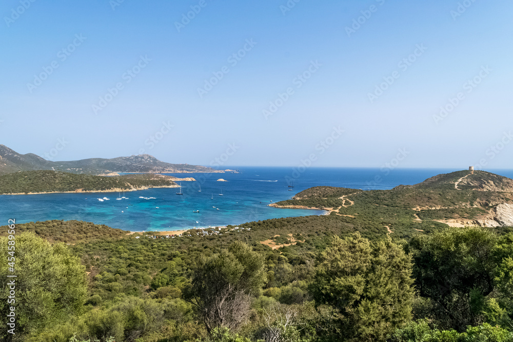 Beautiful view of the southern Sardinian sea. Note the historic Saracen tower on the rock formations.