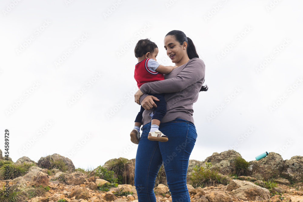 mom carrying the baby on the mountain