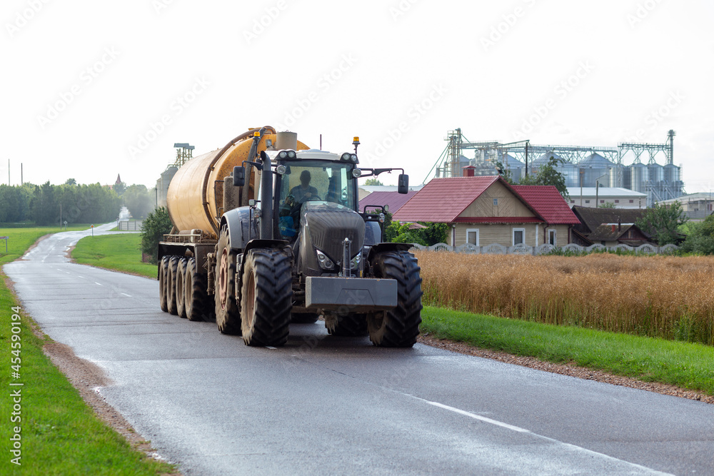 A tractor with a modern fertilizer trailer