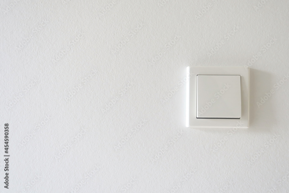 White light switch on a white wall.