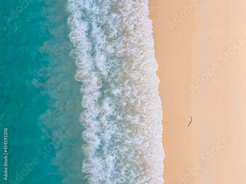 (Top view) Aerial view drone over beach sea. Beautiful sea waves. Beach sand and amazing sea. Summer sunset seascape. Phuket Thailand Beach. Water texture. Top view of the fantastic natural sunsets © BUDDEE