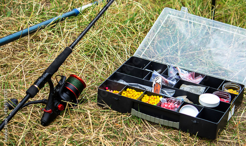 Fishing tackle on the river bank, bait rod, spinning rod, fish. Selective focus