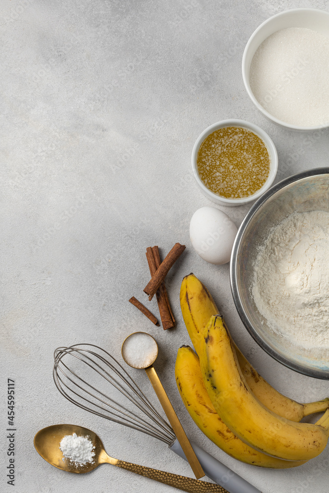 Ingredients for banana bread in bowls on light gray background top view Ingredients for banana bread in bowls on light gray background top view