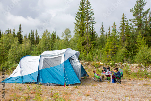 Happy family with three kids, wild camping in Norway summertime © Tomsickova