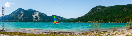 lake and mountains in summer. Panoramic landscape scenery of Beach of Bavaria Lake Walchensee. European Alps in Germany, Europe Bavarian Prealps. Sailing, catamaran on the lake. Web banner